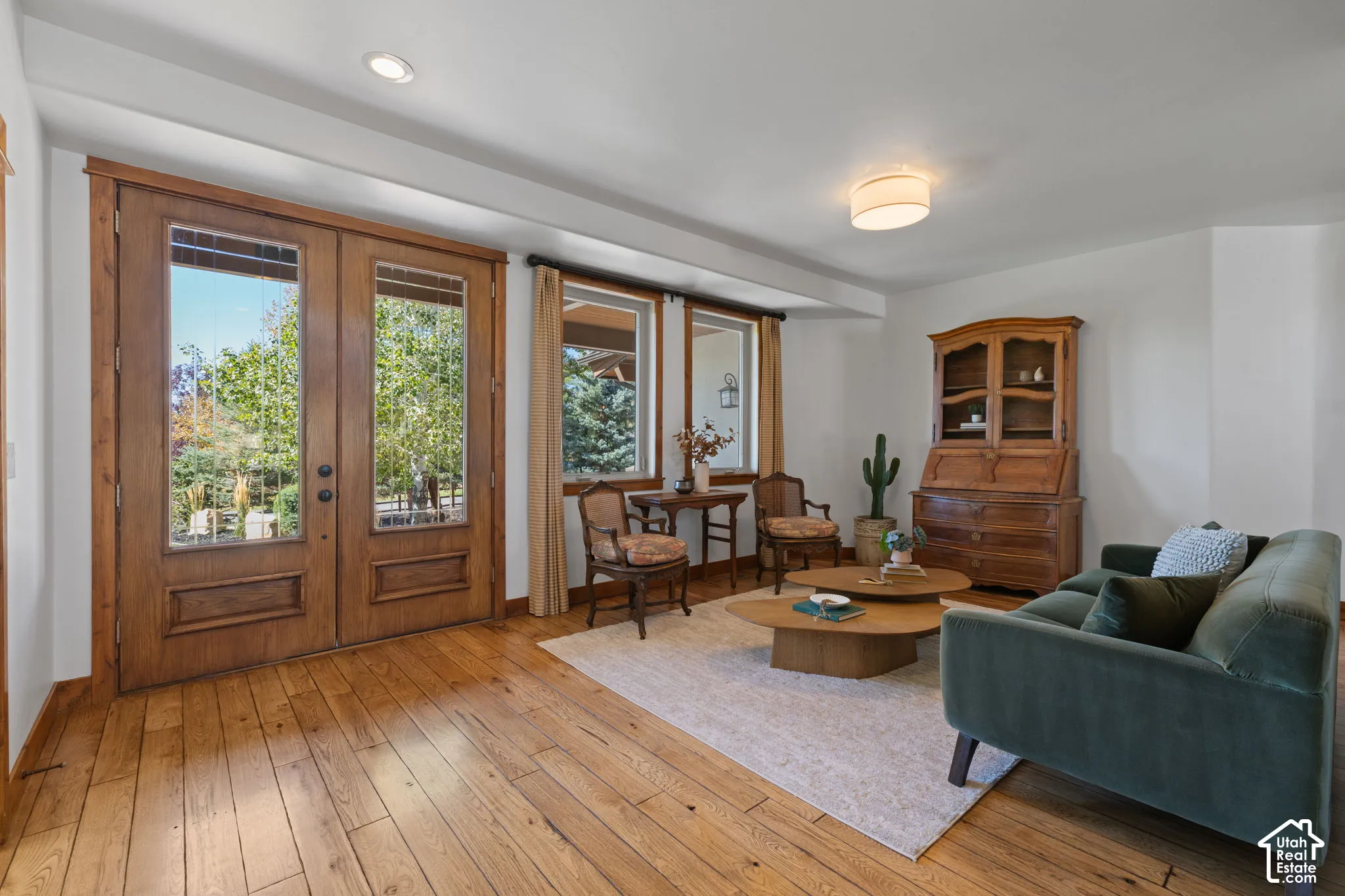 Wood-finish flooring throughout, recessed lighting, and a flush mount ceiling fixture