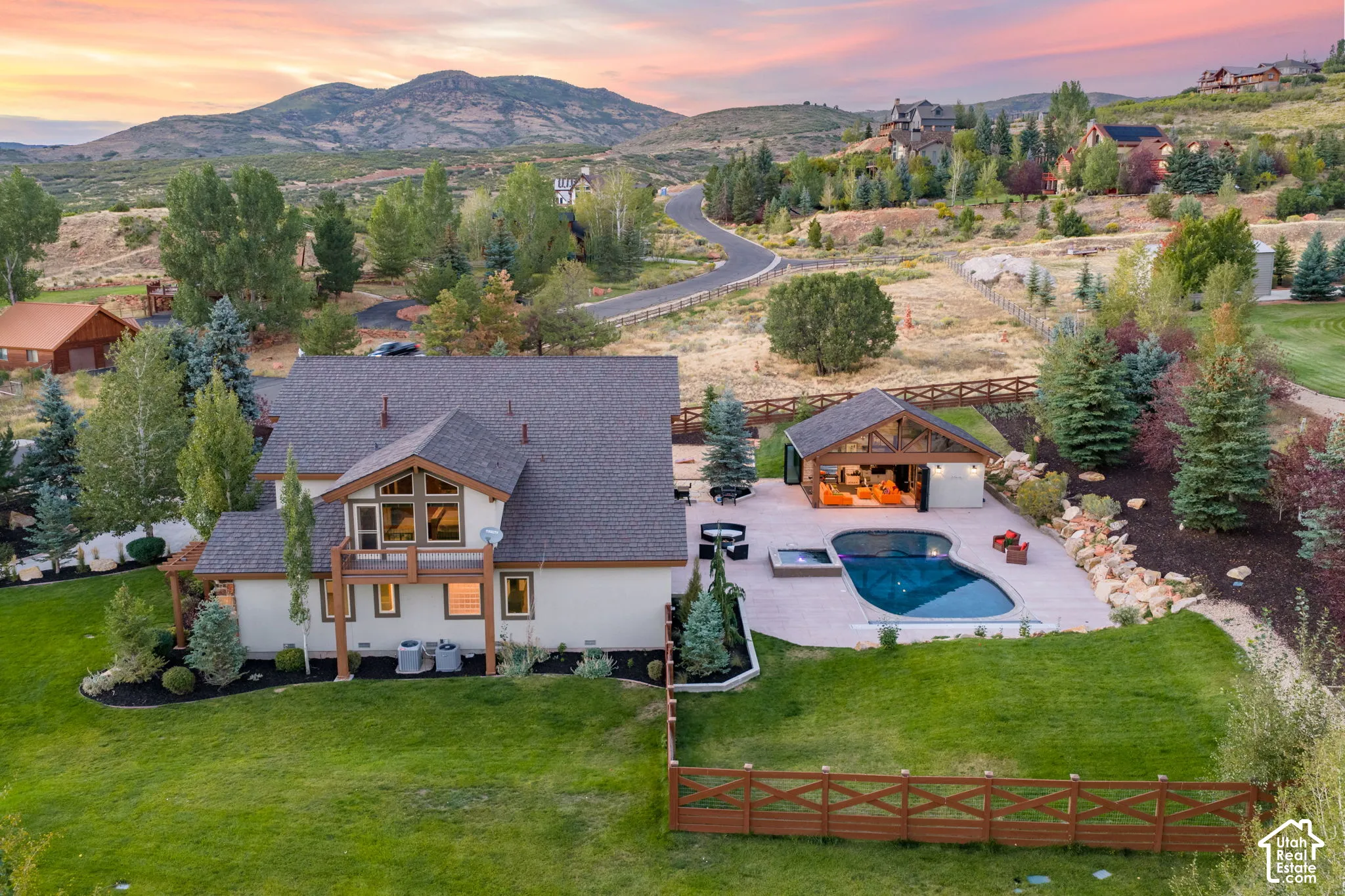 Expansive backyard featuring a manicured lawn, a freeform swimming pool, and an integrated spa
