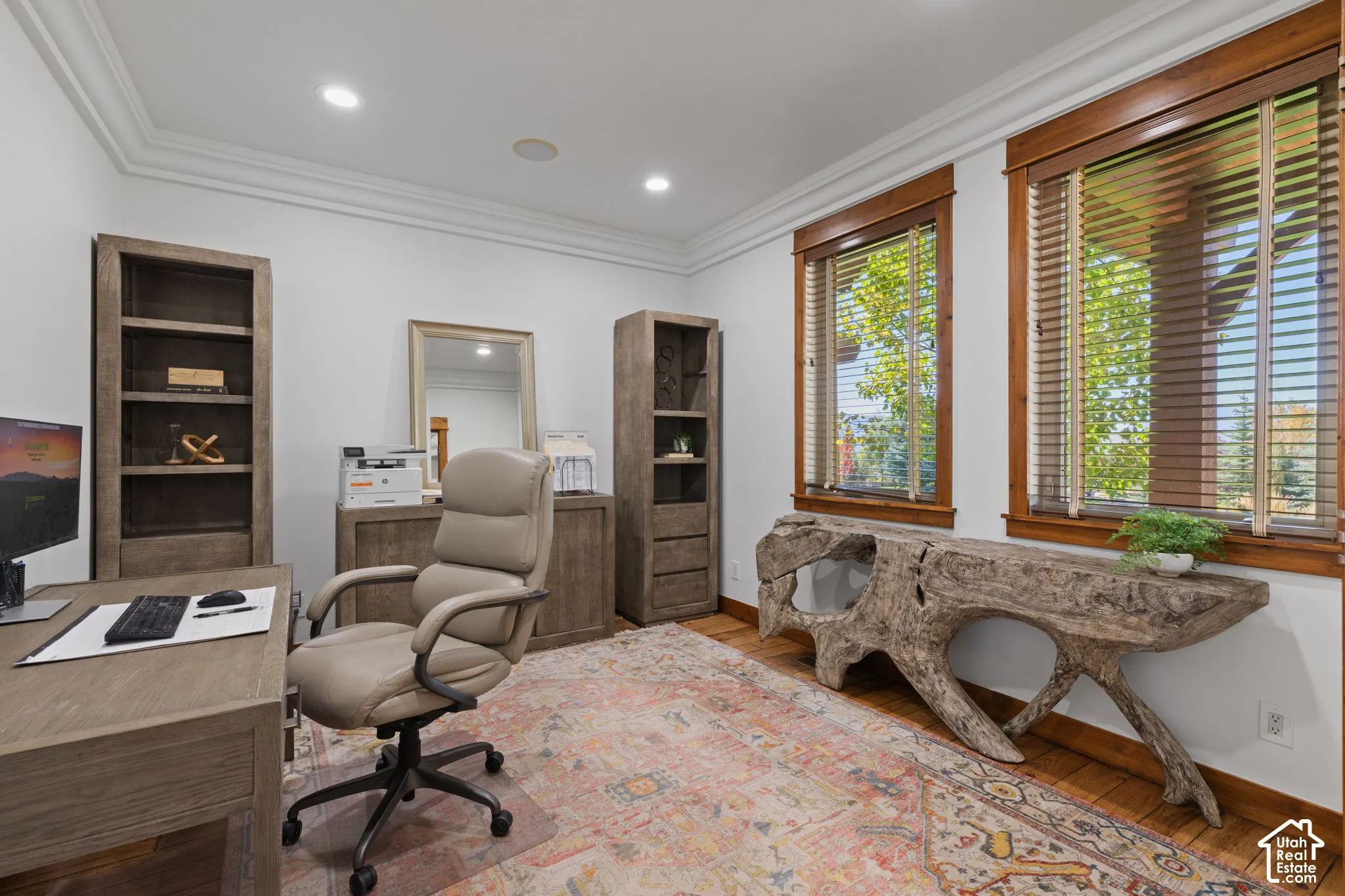 Hardwood flooring, recessed lighting, crown molding, and wood-framed windows with blinds