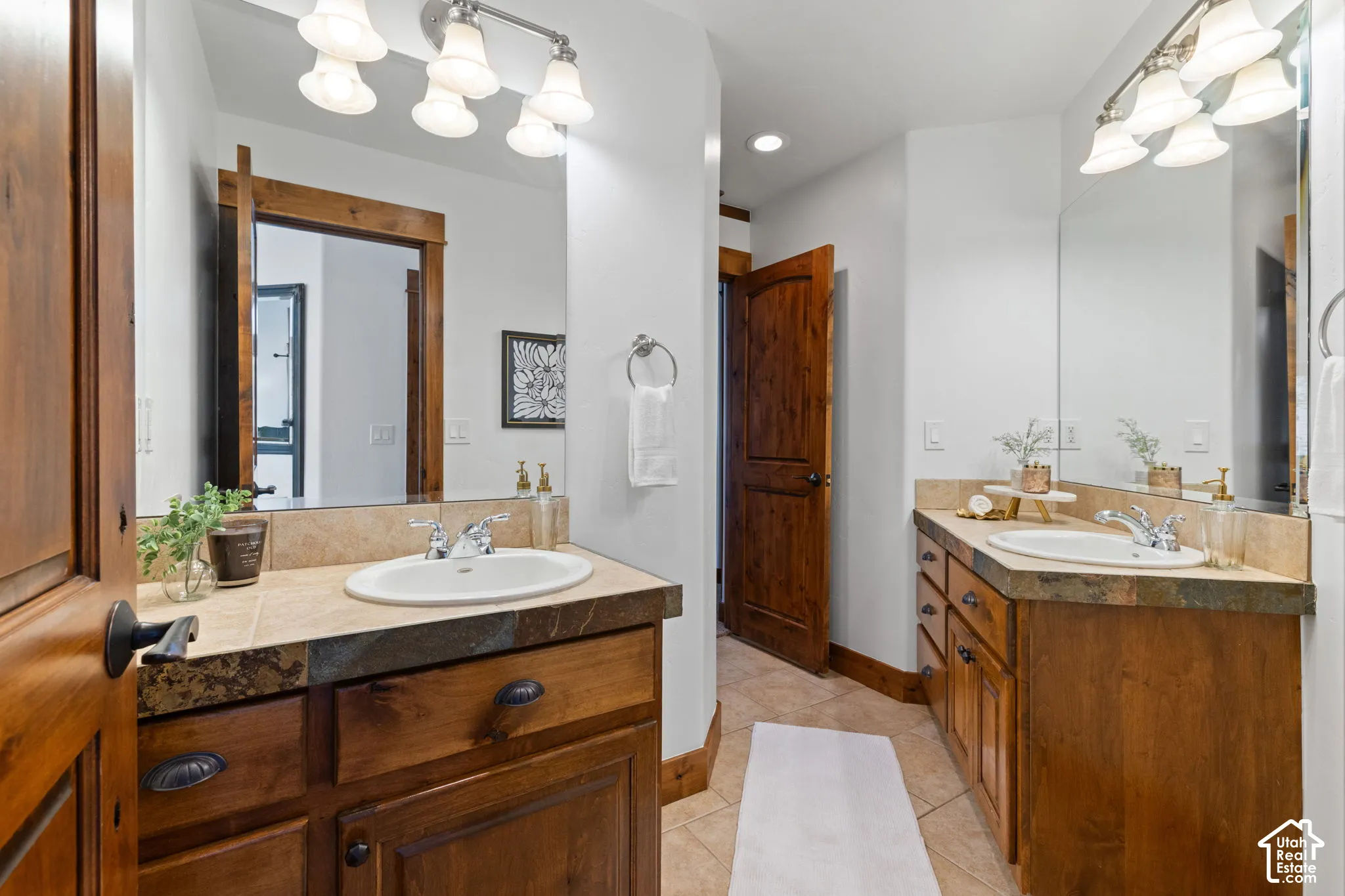 Dual wood-finish vanities with tile countertops and integrated sinks