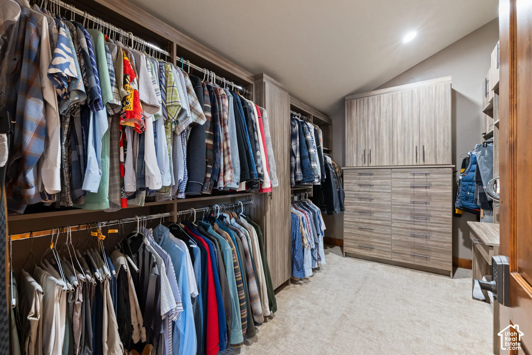 Built-in closet system with multiple hanging rods and shelving