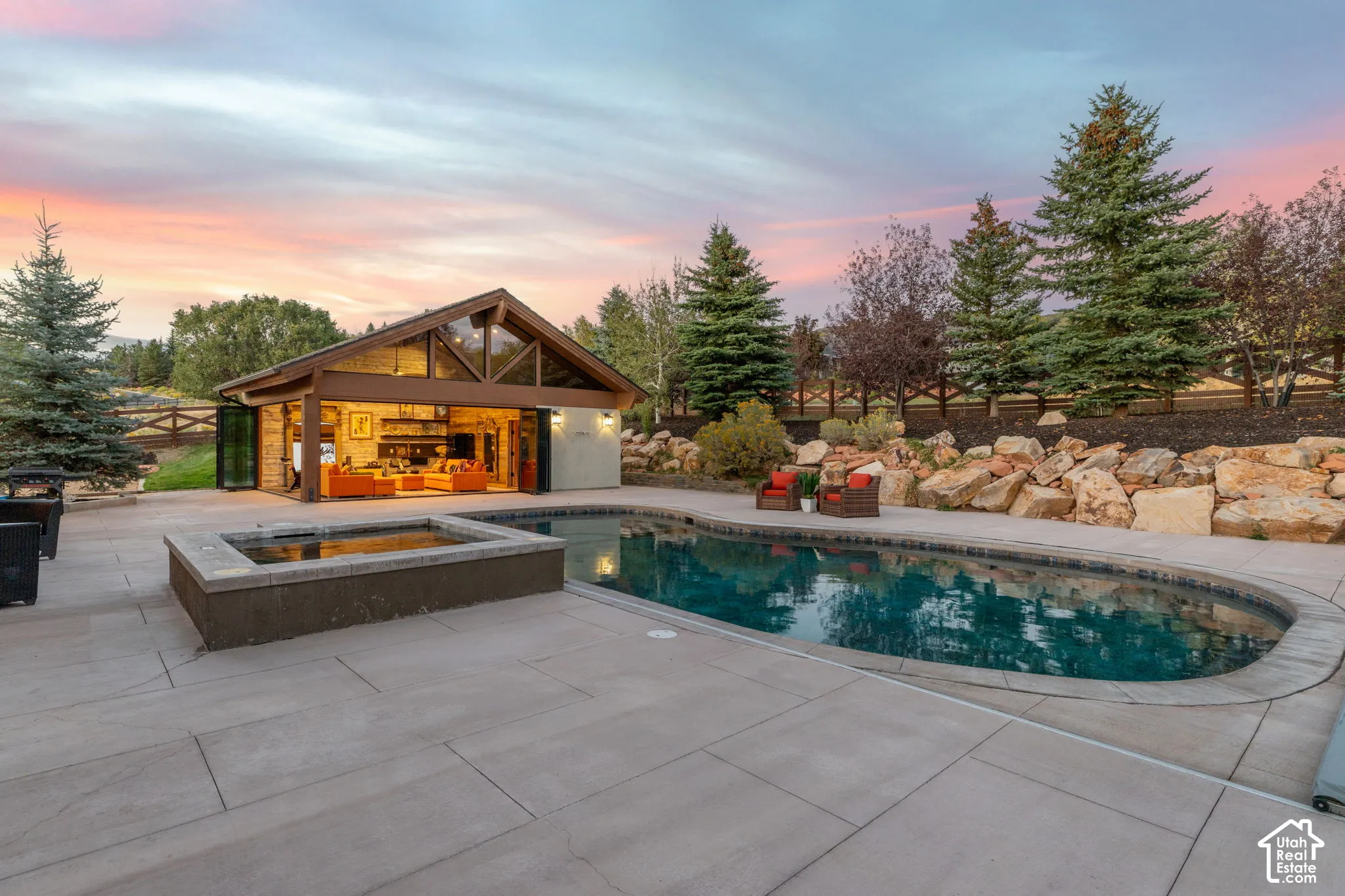Spacious backyard featuring a built-in swimming pool, integrated hot tub, and large patio