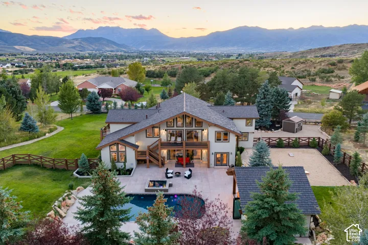 Expansive exterior featuring a swimming pool, integrated spa, and an attached outdoor patio