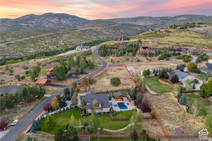 Expansive lot featuring a residential structure, a swimming pool, and mature trees