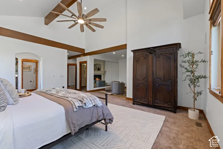 Vaulted ceiling with exposed wood beams and a contemporary ceiling fan