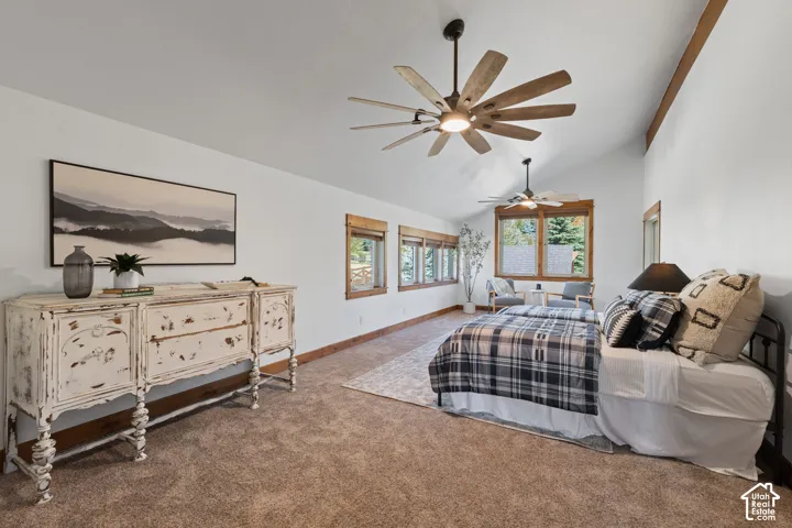 Vaulted ceilings featuring exposed wood beams, wood-frame windows, and recessed lighting