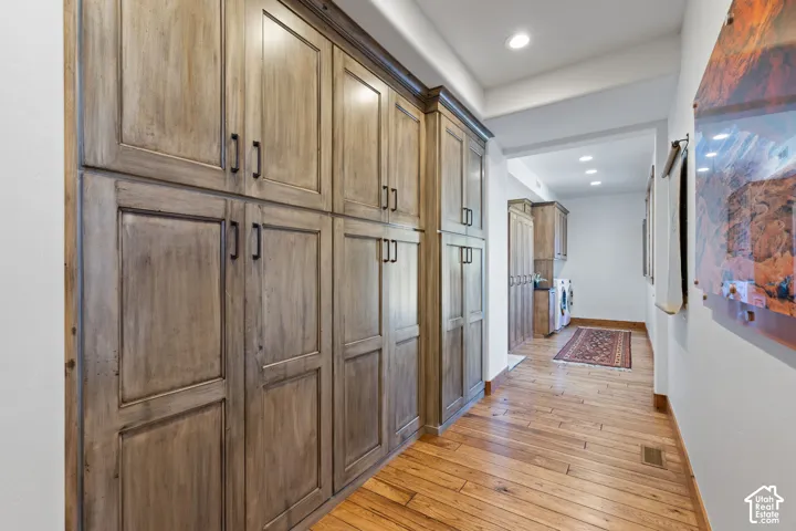 Extensive built-in wood-finish cabinetry, recessed lighting, and wood-finish flooring