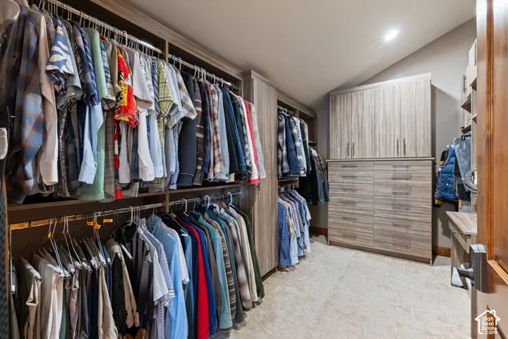 Built-in closet system with multiple hanging rods and shelving