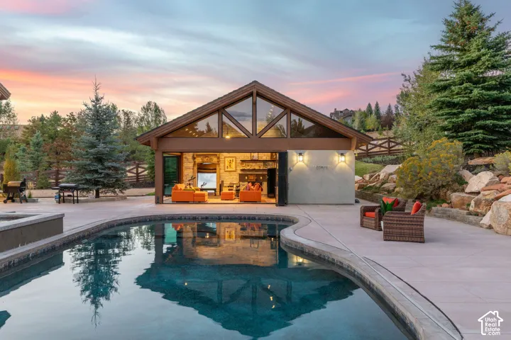 Outdoor pool featuring a curved edge and integrated spa
