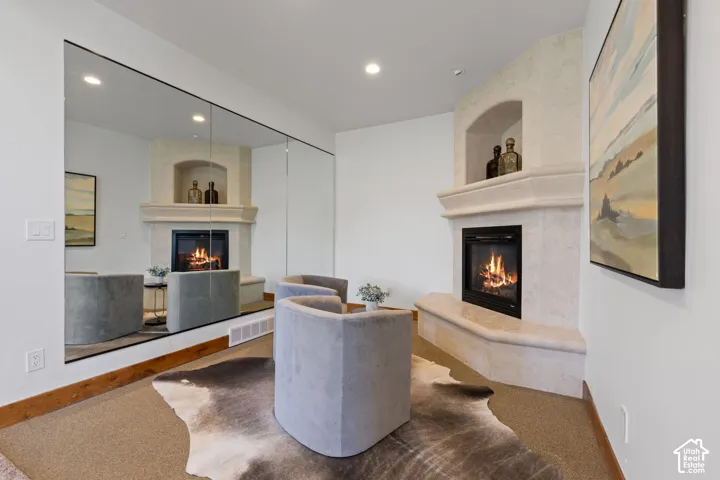 Corner fireplace with a plaster finish and built-in niche