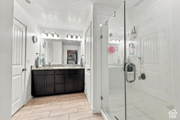 Dual vanity with dark wood cabinetry and stone-finish countertop