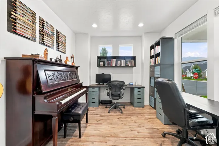 Recessed lighting illuminates the wood-finish flooring