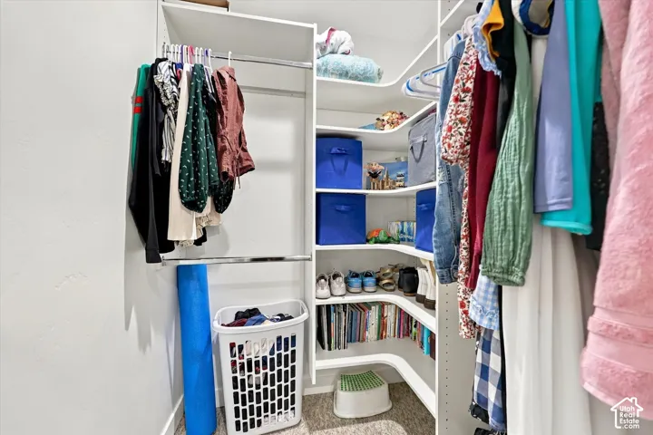 Built-in closet system featuring multiple shelves, two hanging rods, and corner shelving