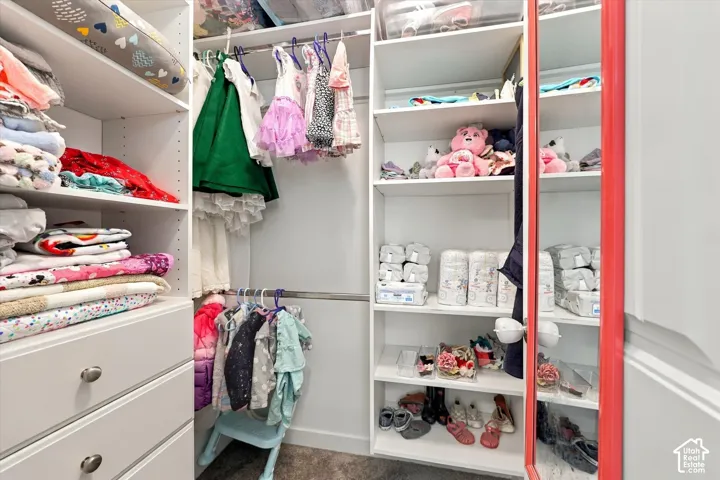 Custom closet system featuring built-in shelving, hanging rods, and integrated drawers with metal hardware