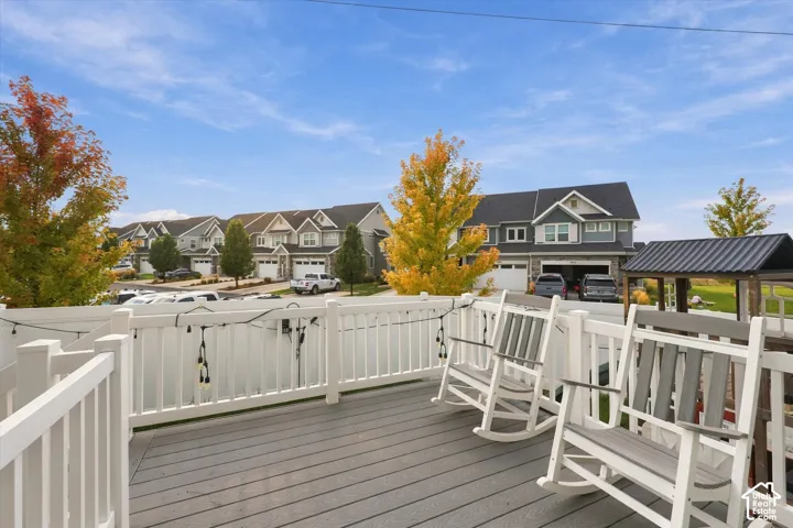 Outdoor deck featuring composite decking, white railing, and string lighting