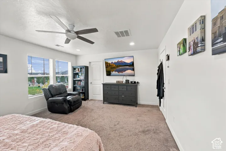 Recessed lighting, ceiling fan, and carpeted flooring