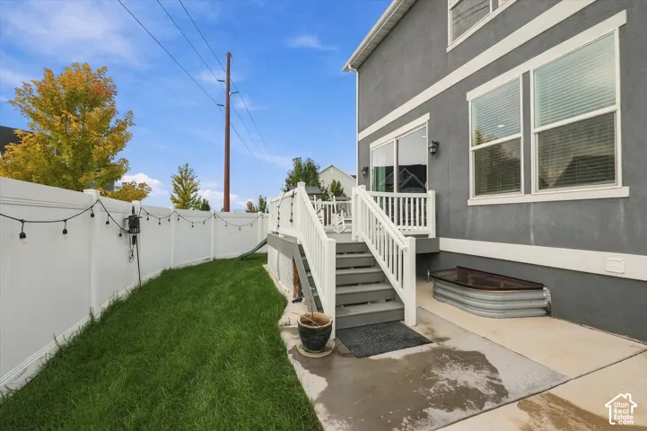 Manicured lawn area with white privacy fencing