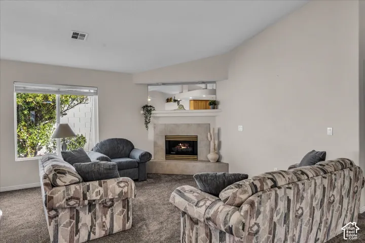 Corner fireplace with a mantel, accent mirror, and neutral surround
