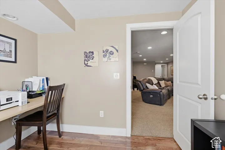 Recessed lighting, wood-finish flooring, and crisp white trim