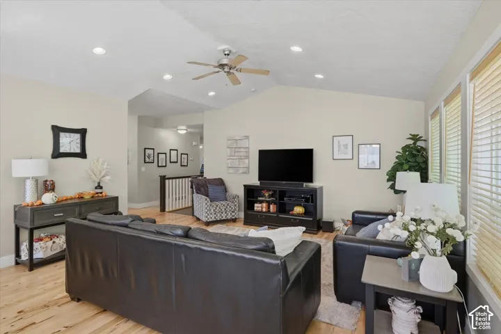 Vaulted ceiling with recessed lighting and a ceiling fan