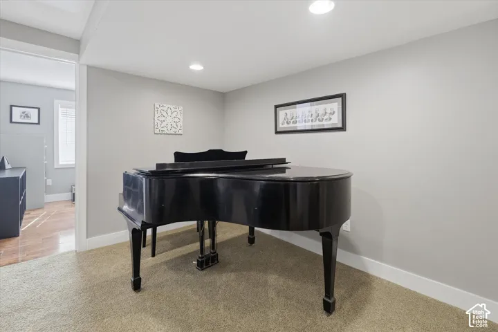 Neutral wall paint, recessed lighting, and carpeted flooring