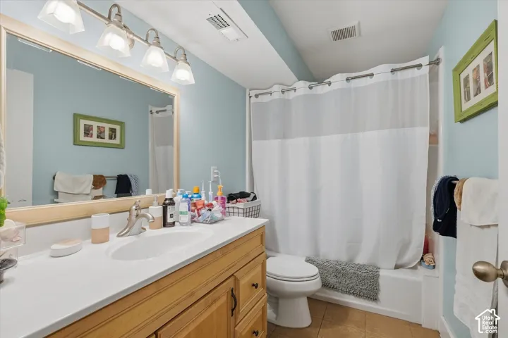 Wood-finish vanity with an integrated sink and light-colored countertop