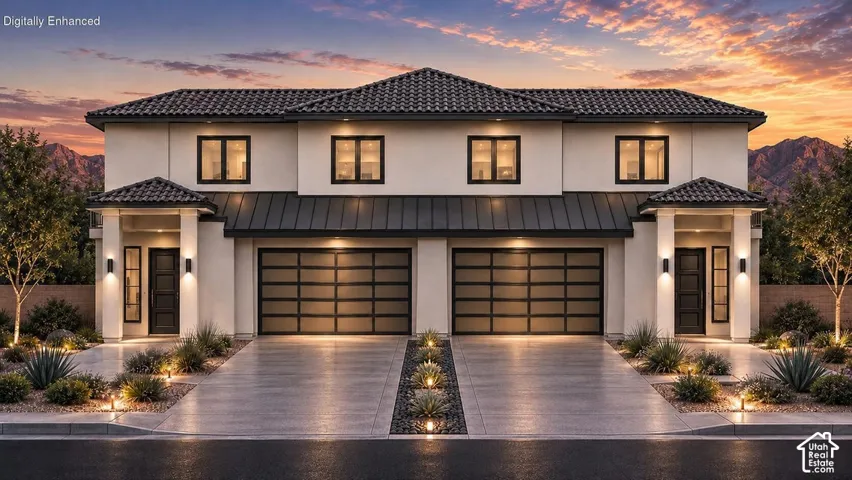 Contemporary stucco exterior featuring a tile roof, two-car garage with frosted glass doors, and a covered entry