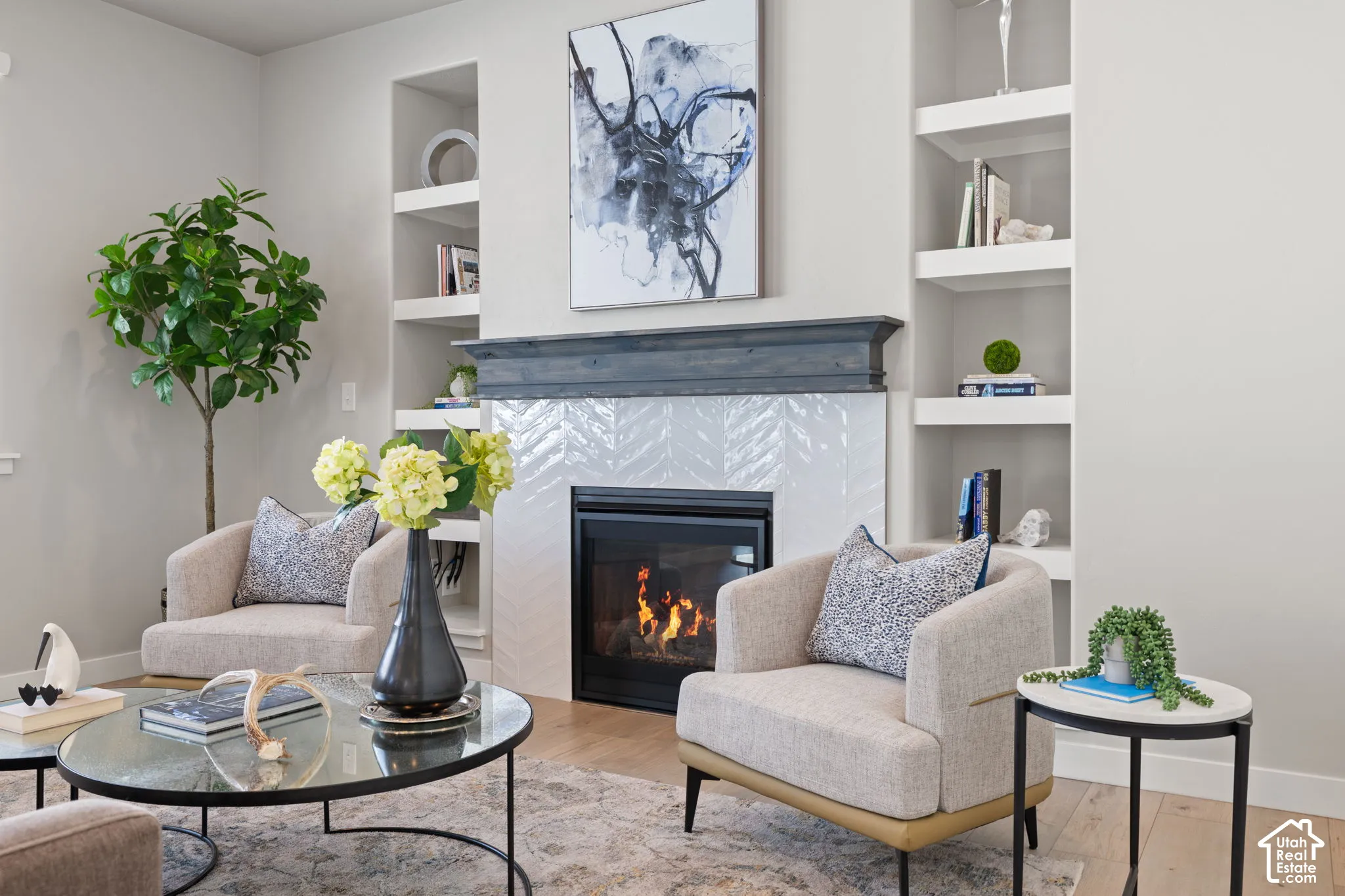 Built-in fireplace with a herringbone tile surround and a wood mantel