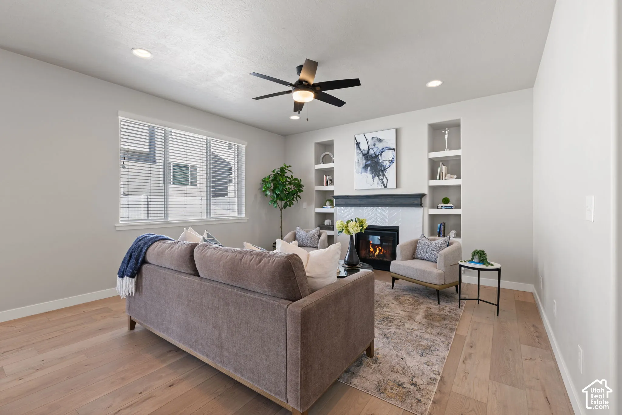 Recessed lighting, light wood-finish flooring, and a ceiling fan
