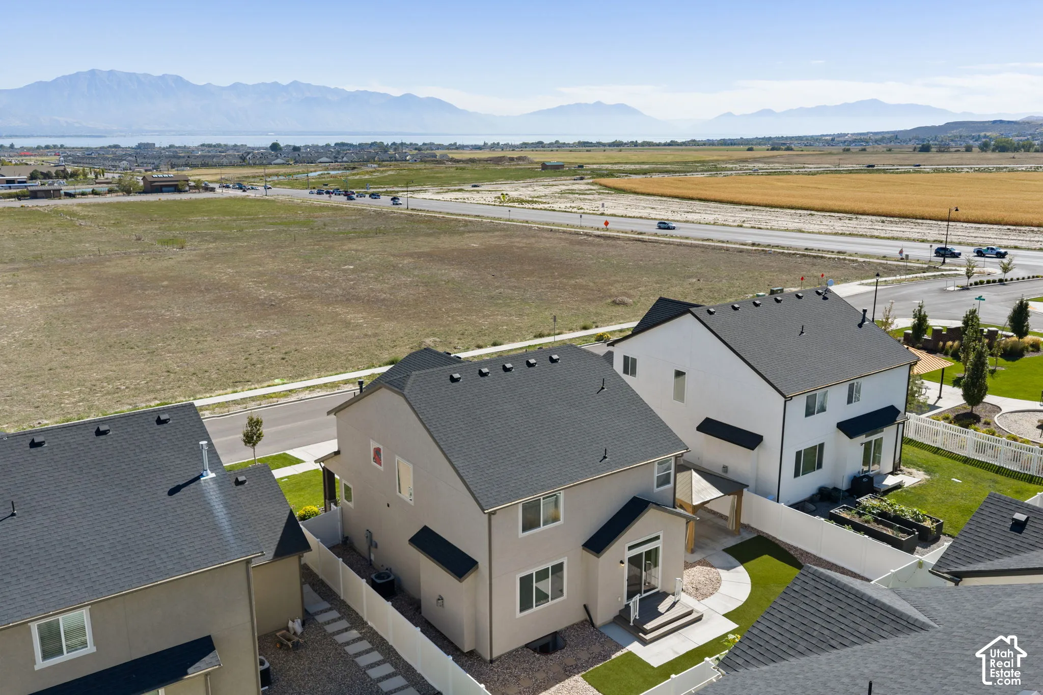 Two-story residence with a dark shingle roof and light-colored siding