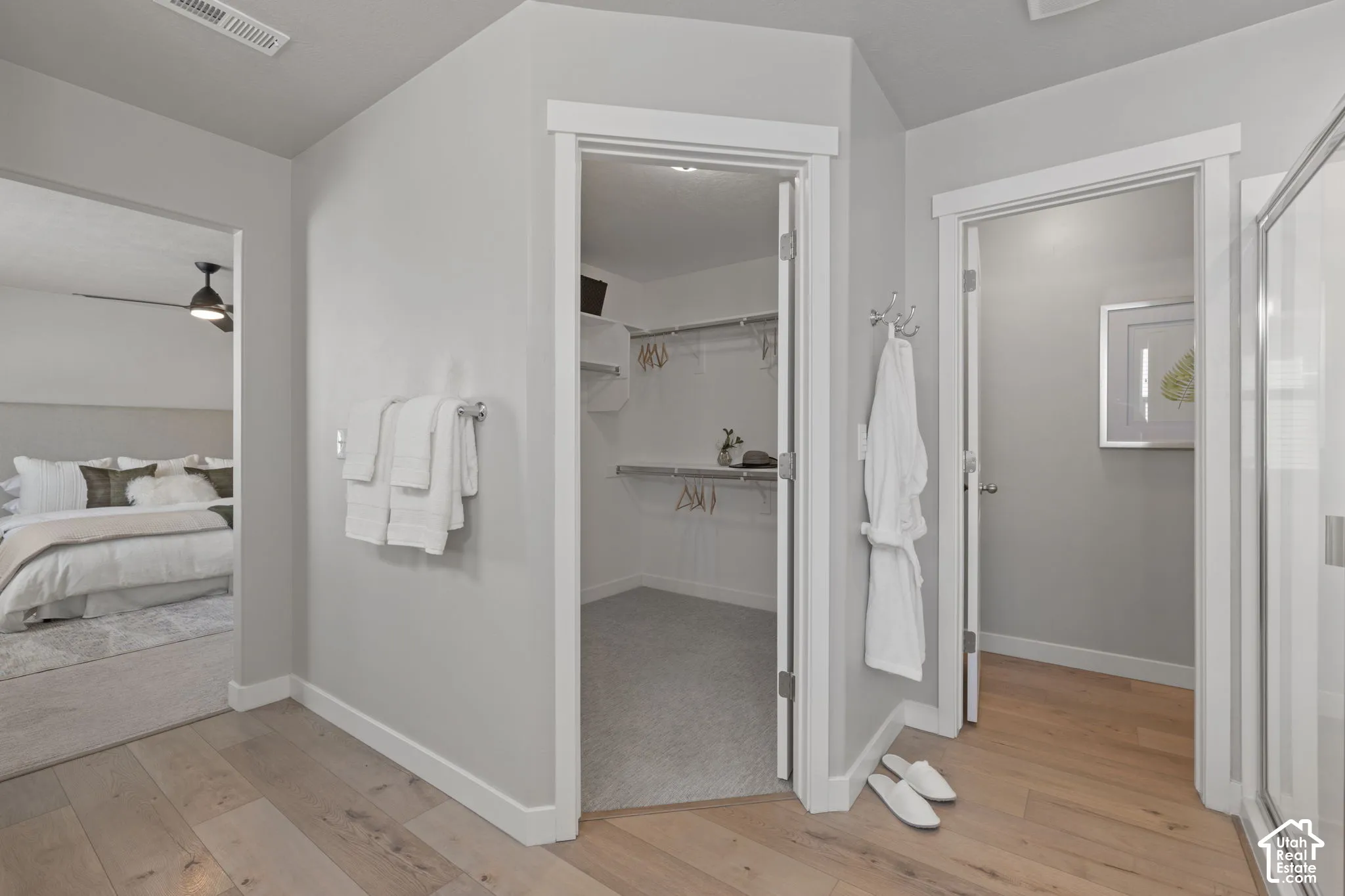 Wood-finish flooring, recessed lighting, and a walk-in closet with built-in shelving