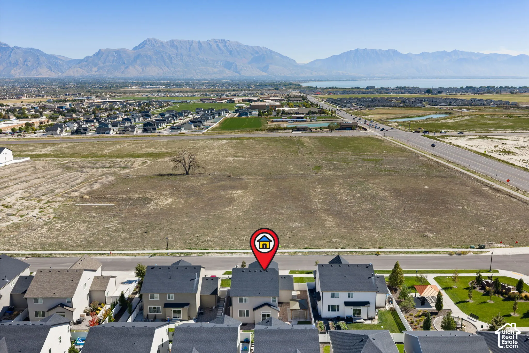 Mountain backdrop, lake scenery, suburban development, nearby roadways, open land