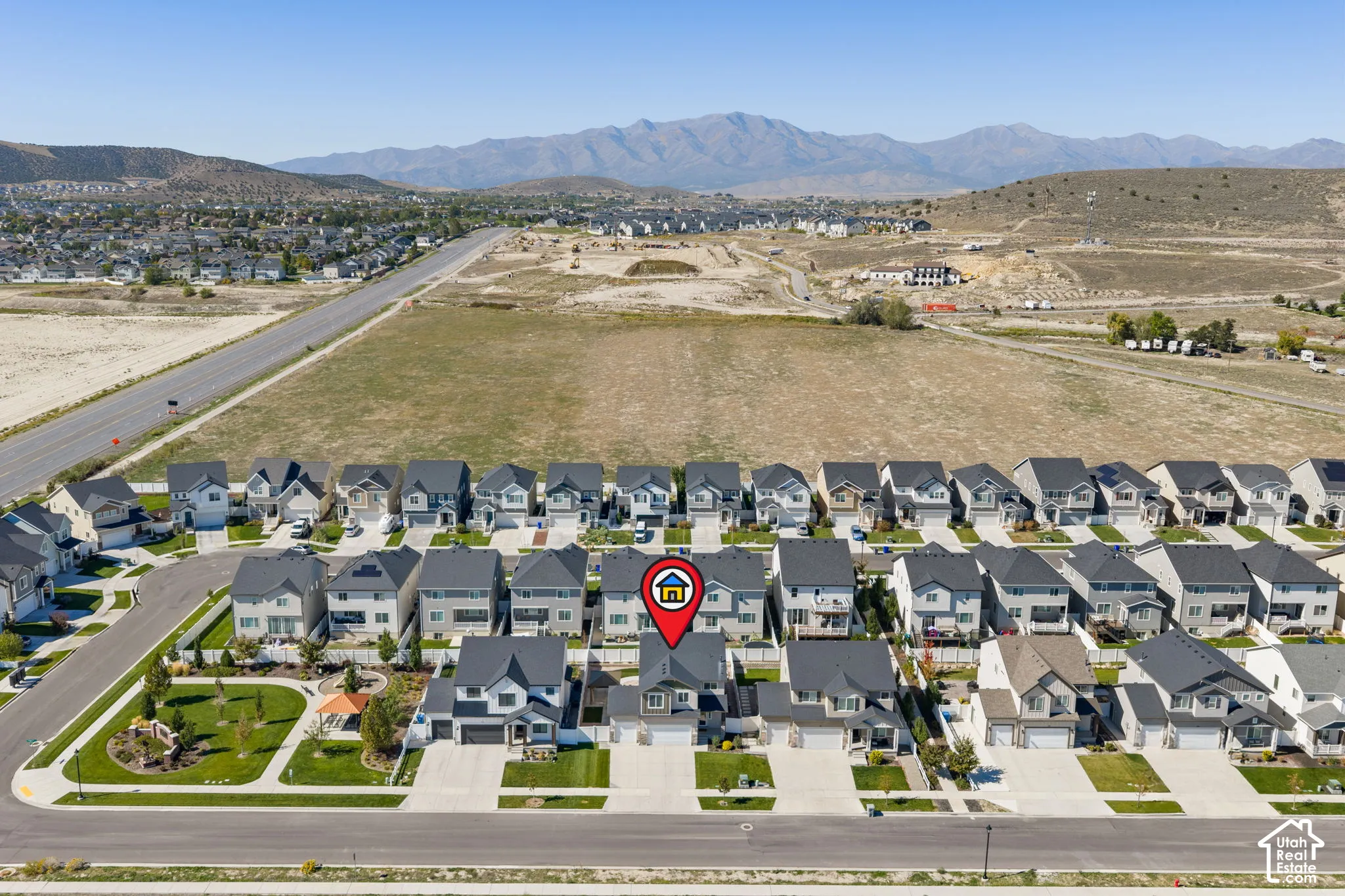Residential community with uniform housing styles and mountain backdrop