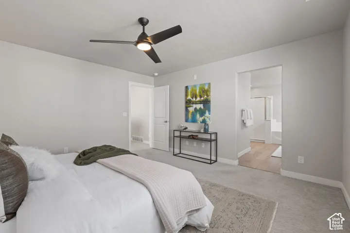 Bedroom featuring a ceiling fan with integrated lighting, light gray wall paint, and a carpeted floor
