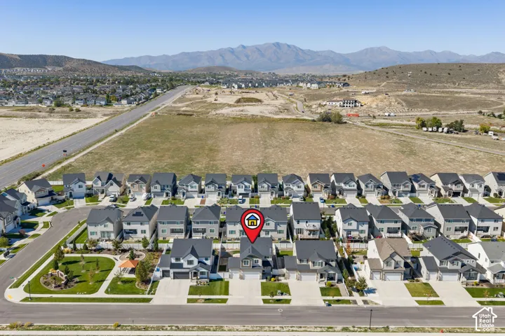 Residential community with uniform housing styles and mountain backdrop