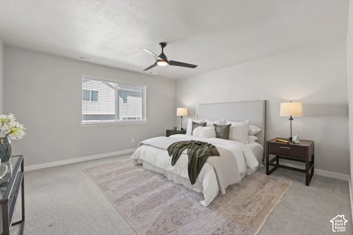 Carpeted room with a ceiling fan, a window with blinds, and light-colored walls