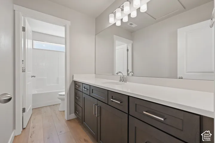 Extended vanity with a white countertop and dark wood-finish cabinetry