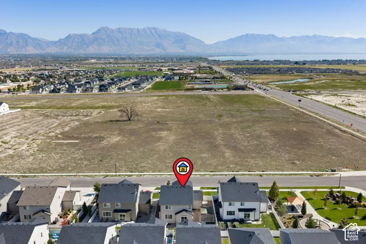 Mountain backdrop, lake scenery, suburban development, nearby roadways, open land
