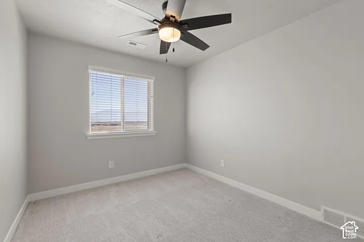 Recessed window with blinds, ceiling fan with integrated lighting, wall-to-wall carpeting, and neutral wall finishes