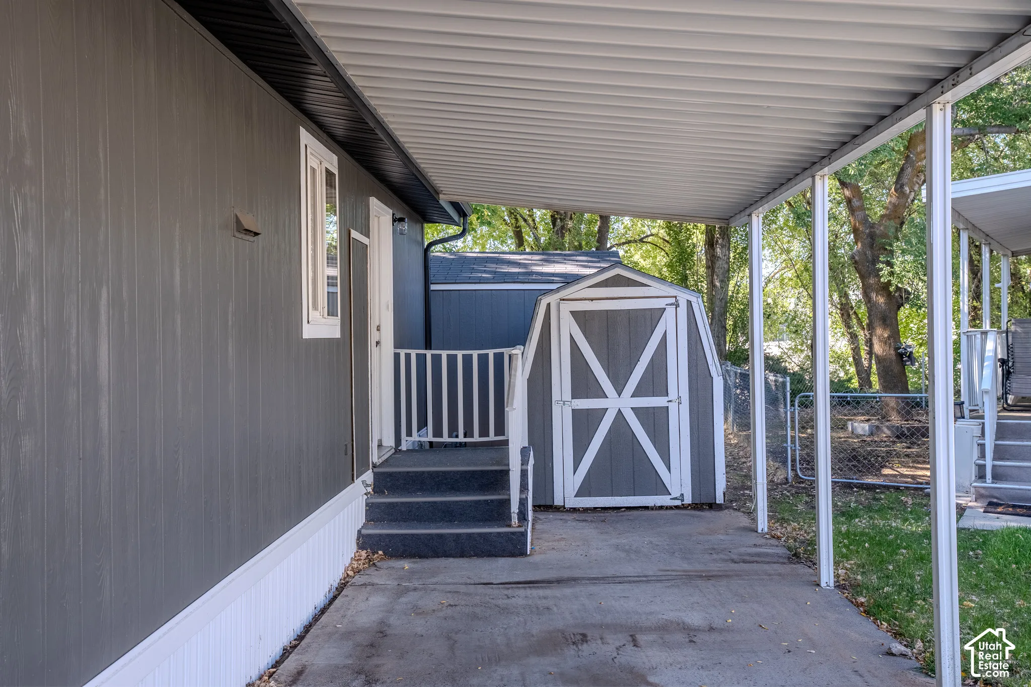 Gray vertical siding exterior with white trim