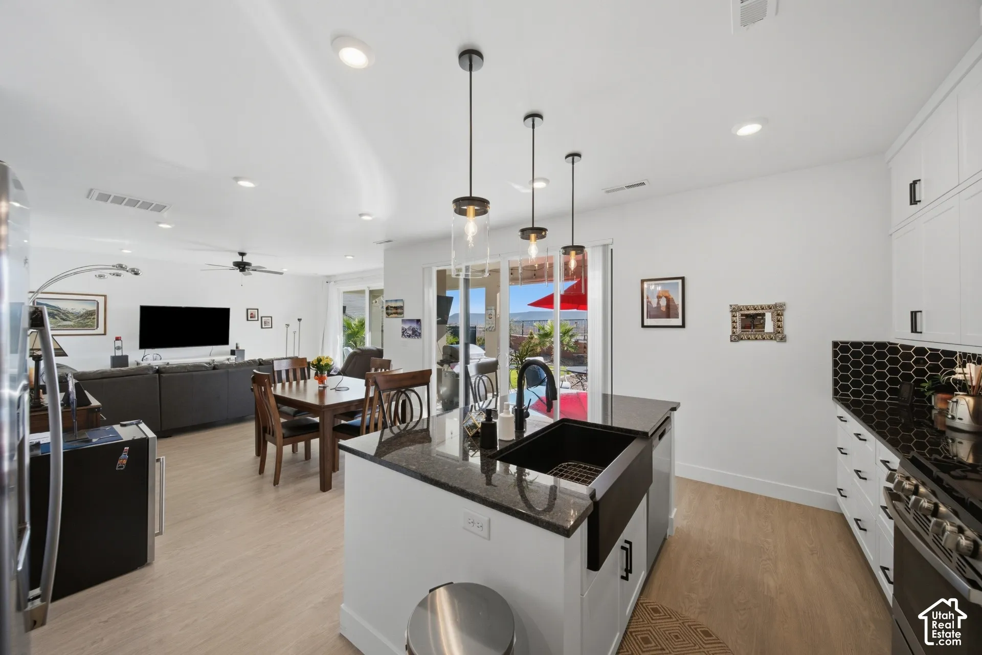 Kitchen with a central island, black farmhouse sink, and pendant lighting