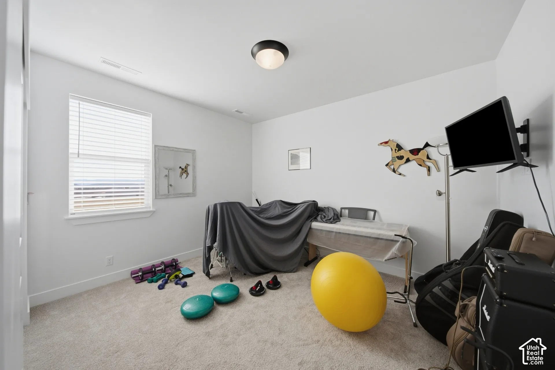 Carpeted interior space with a window featuring horizontal blinds, recessed lighting, and a wall-mounted flush light fixture