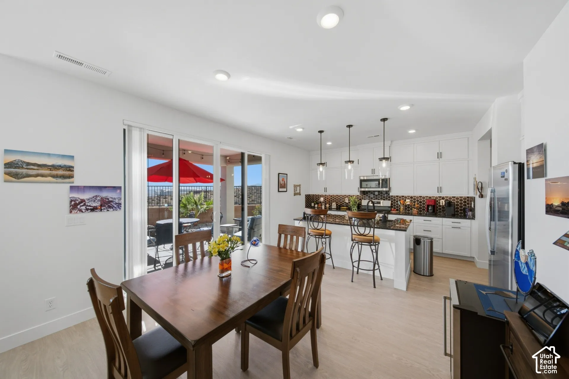 Open-concept living space featuring wood-finish flooring and recessed lighting