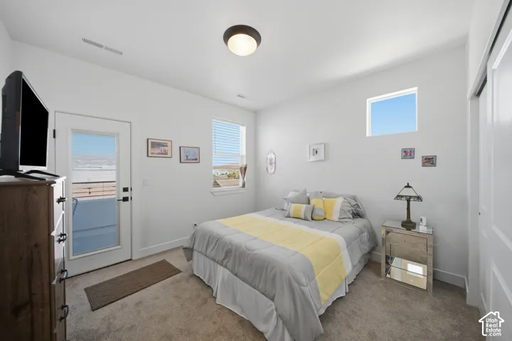 Carpeted room with high ceilings, recessed lighting, and white walls