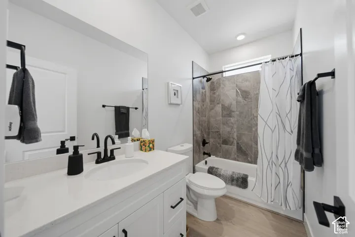 White vanity with a light-toned countertop and matte black hardware