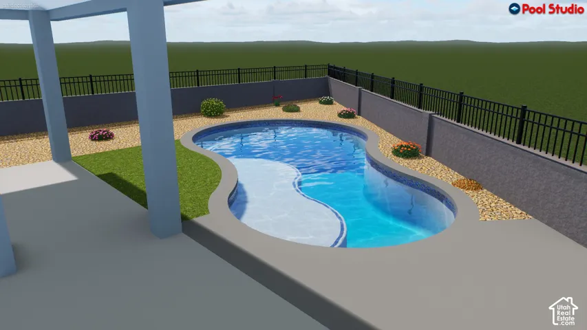 Curved inground pool with dual-tone surfacing, surrounded by a concrete patio and a gravel-mulched perimeter