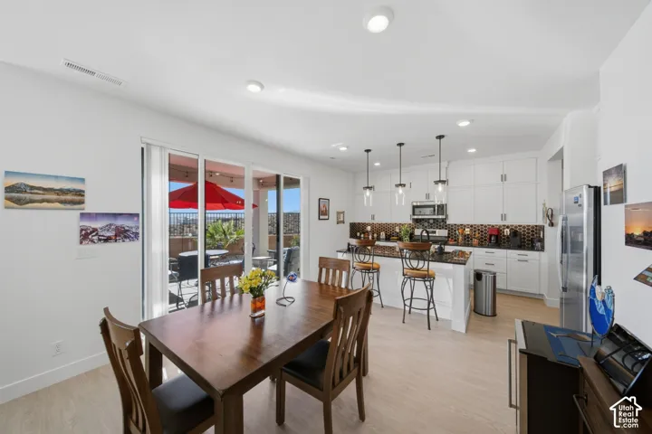 Open-concept living space featuring wood-finish flooring and recessed lighting