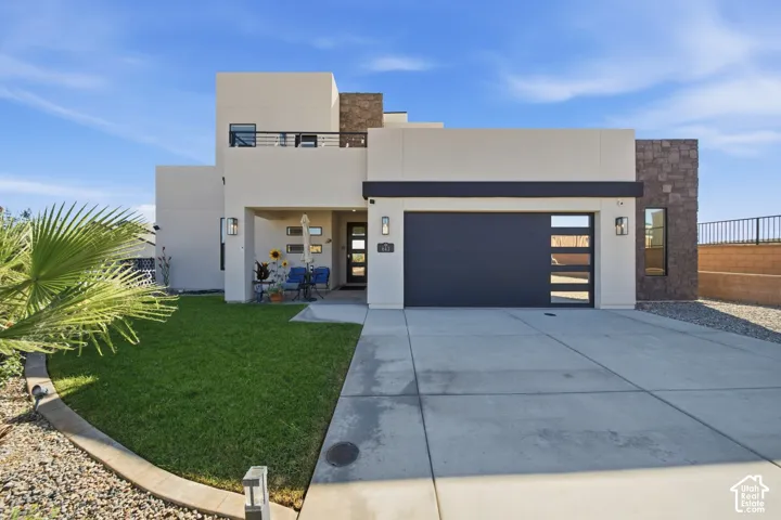 Modern facade featuring a flat roofline, stucco exterior, and stone accents