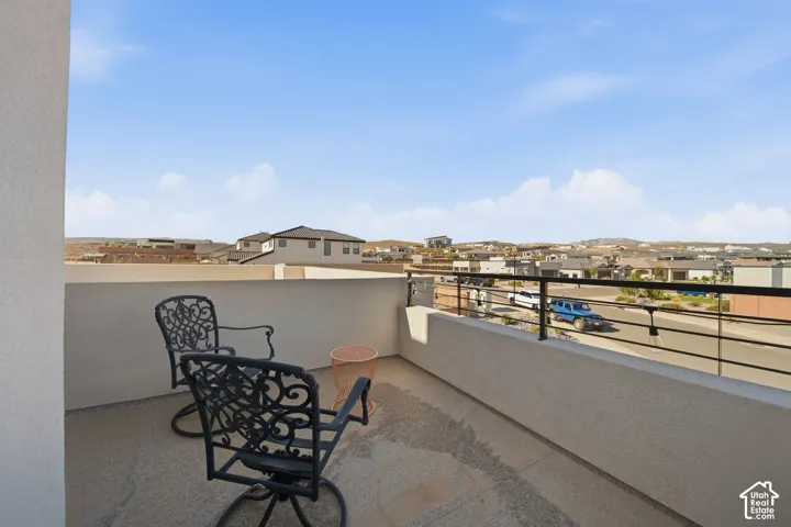 Outdoor balcony featuring a concrete surface and a black metal railing