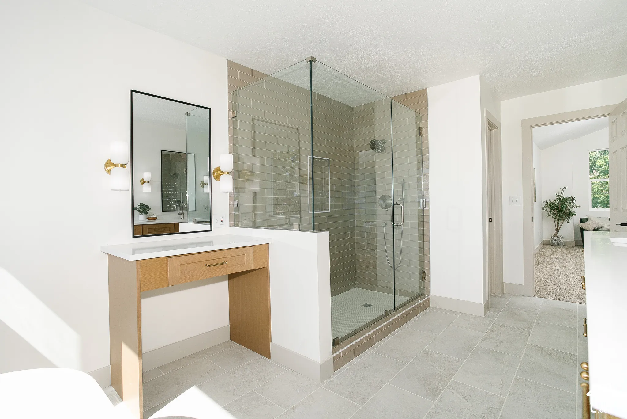 Glass-enclosed shower with subway tile surround